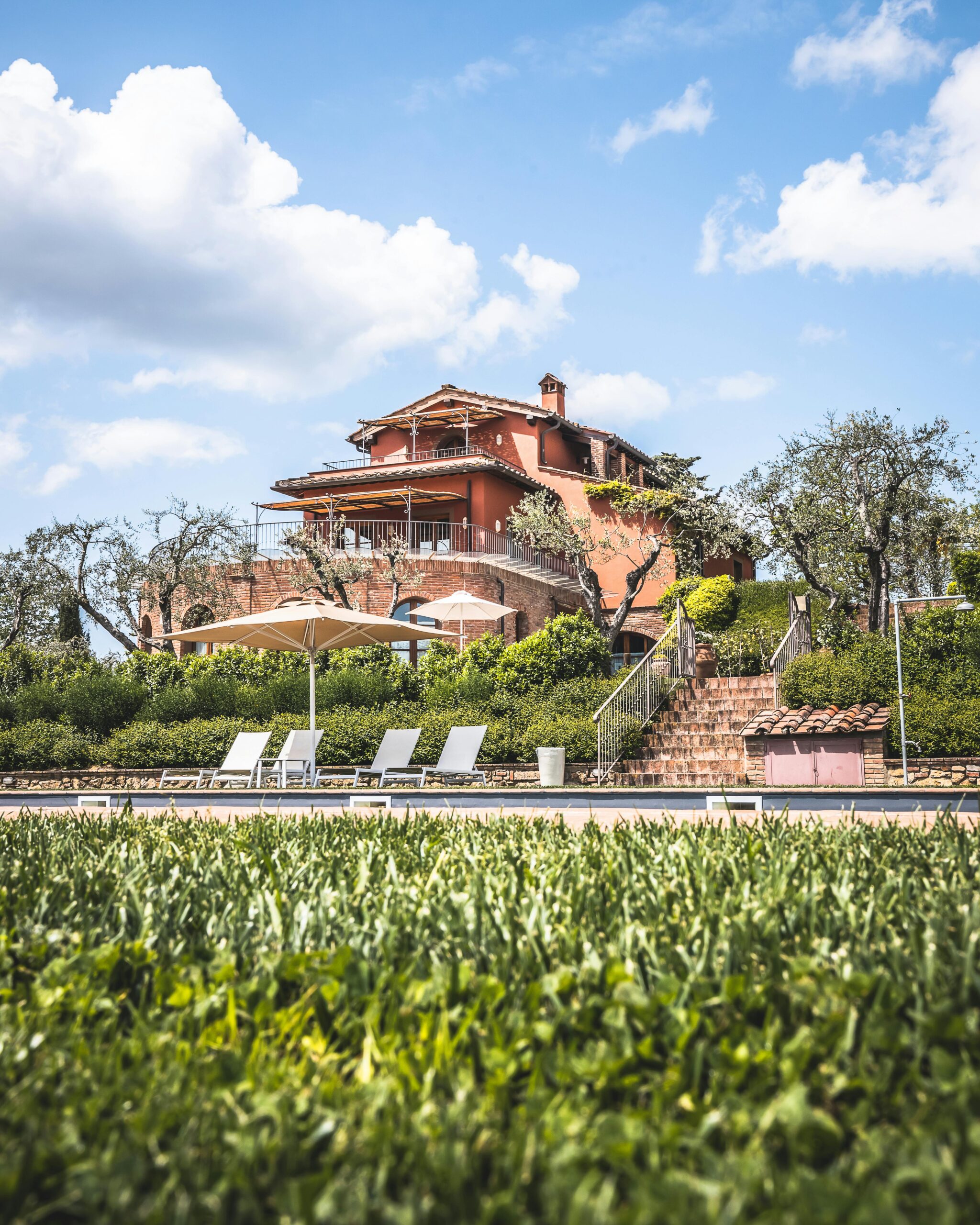 A beautiful villa and garden under blue skies, perfect for a serene vacation.